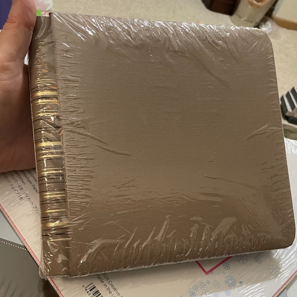 Creative Memories 7”x7” brown album with strips on binding